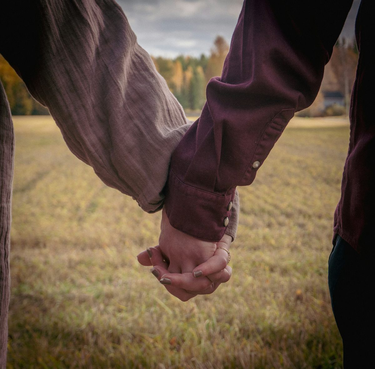 Duas pessoas de mãos dadas, simbolizando apoio